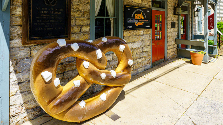 giant pretzel in front of an old building