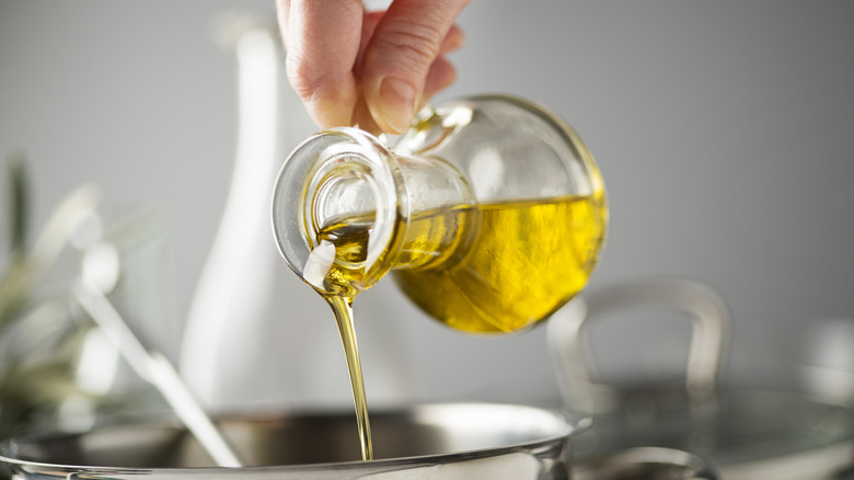 pouring olive oil into pot