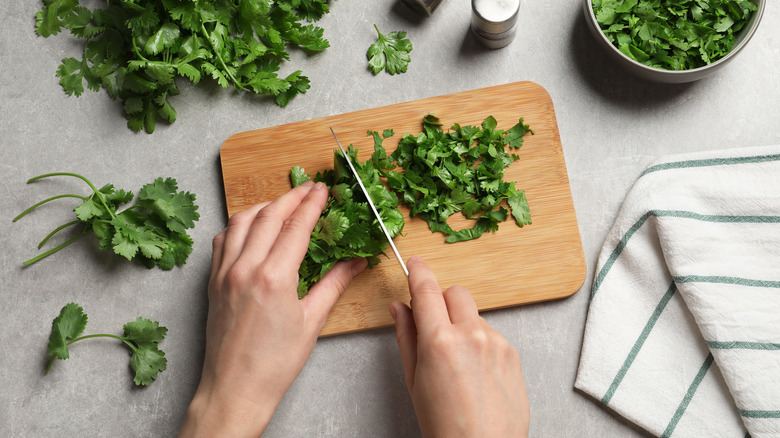 hand chopping parsley leaves with knife