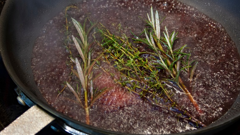 a pan being deglazed with red wine