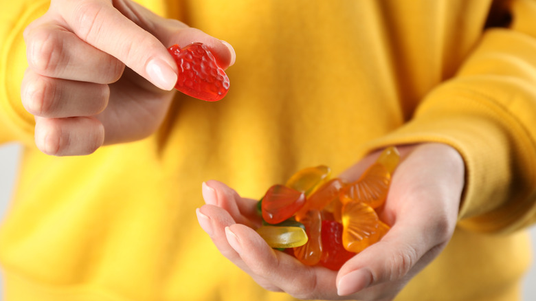 Person holding gummy fruit snacks