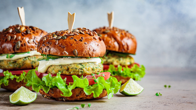 three vegetarian falafel burgers with tomatoes and lettuce