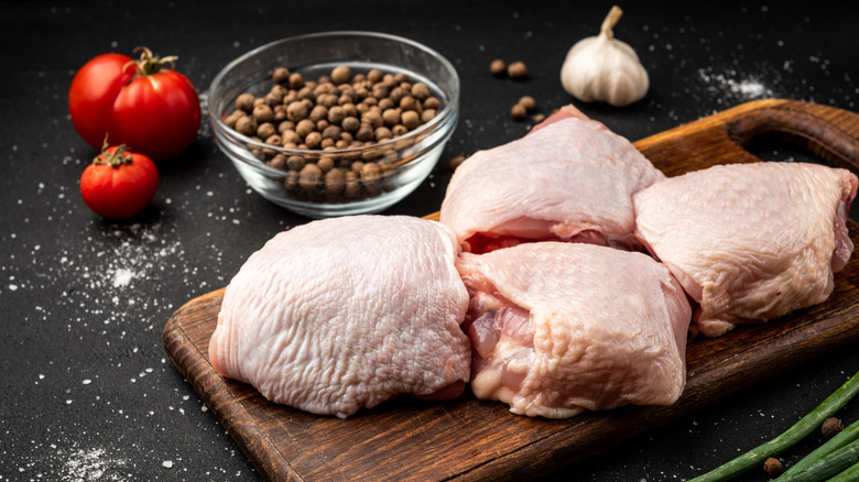 Chicken thighs on chopping board