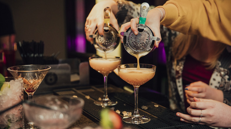 Bartender pours drink 