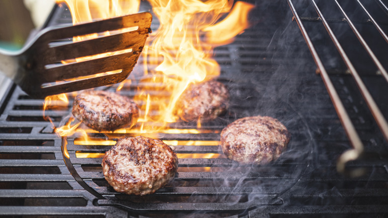 Flipping patties on a grill