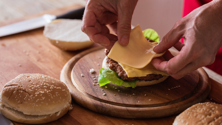 Person putting a hamburger together