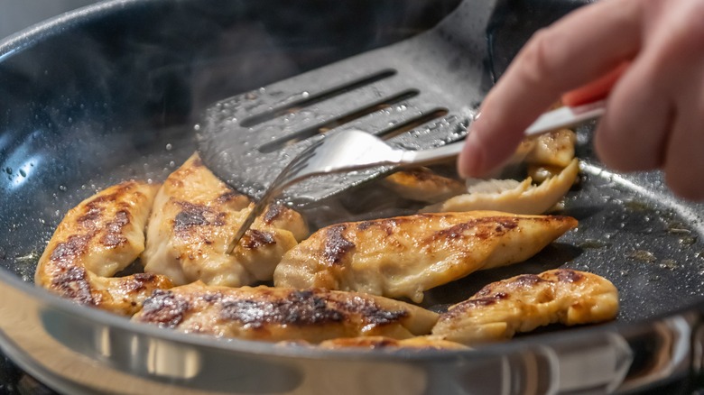 Searing chicken in hot pan 