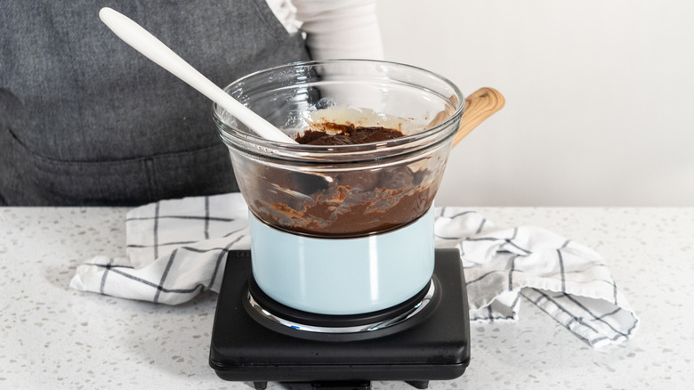 One double boiler warming chocolate on countertop