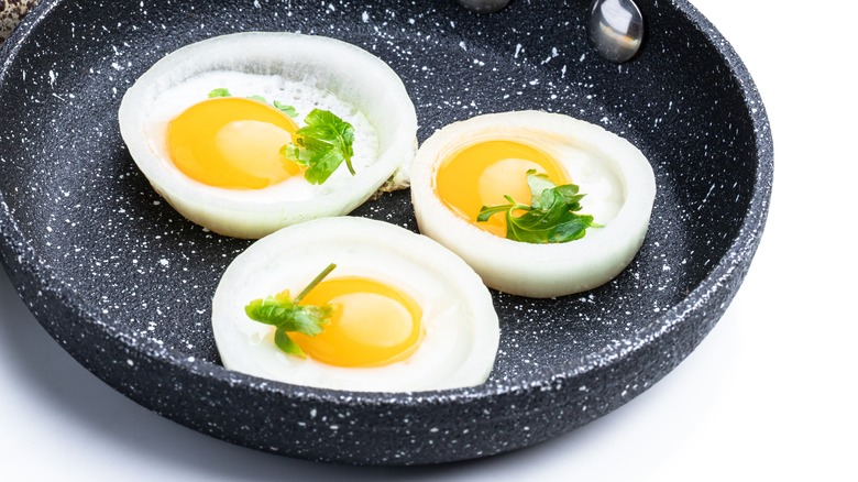 Eggs frying in onion rings