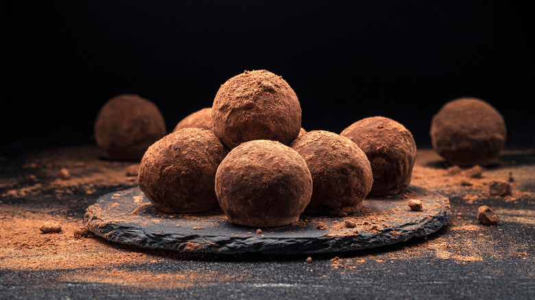 Stacked cocoa chocolate truffles plate