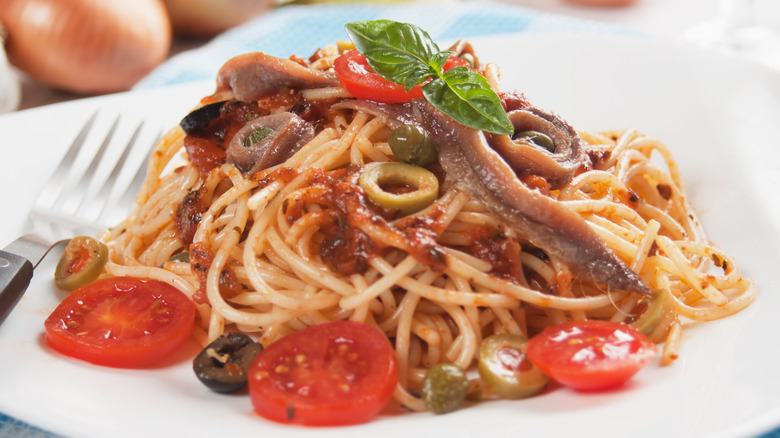 Spaghetti with anchovies, olives, garlic