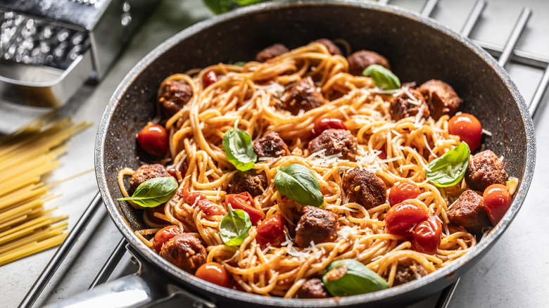 Garnished spaghetti meatball in skillet