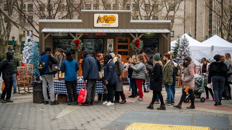 People gather in front of a Cracker Barrel