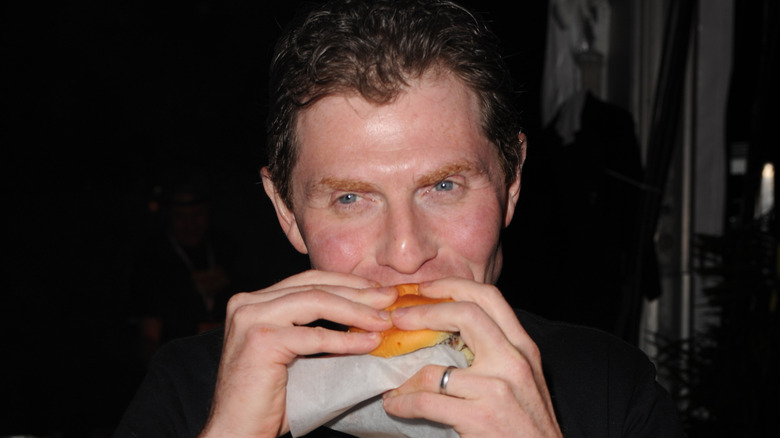 Bobby Flay eating a burger