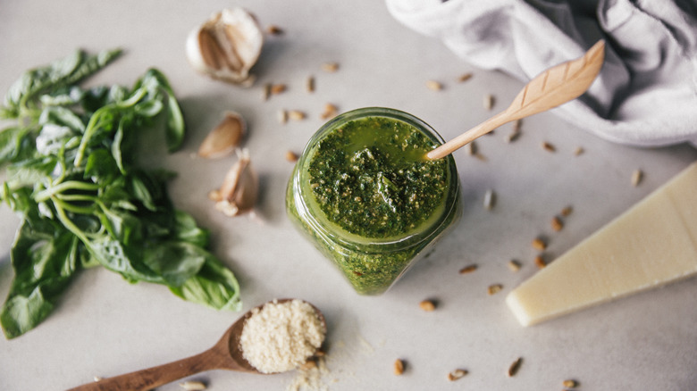 Pesto in jar with ingredients