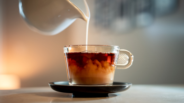 pouring milk into tea