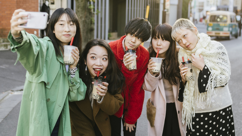 group taking selfie with boba tea