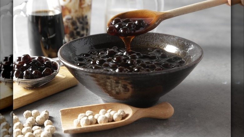 bowl of boba with spoon and raw boba beside it