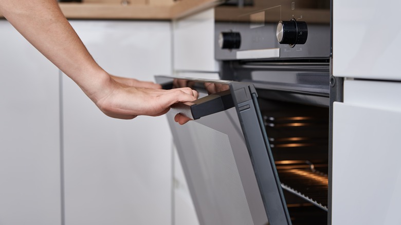 hand opening oven door