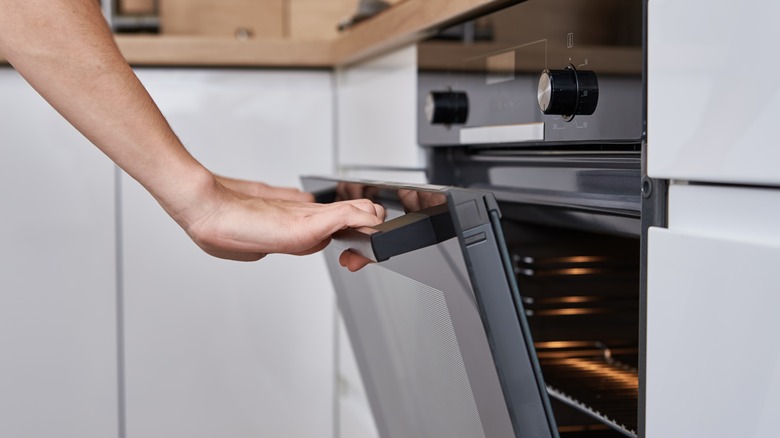 Woman opening oven