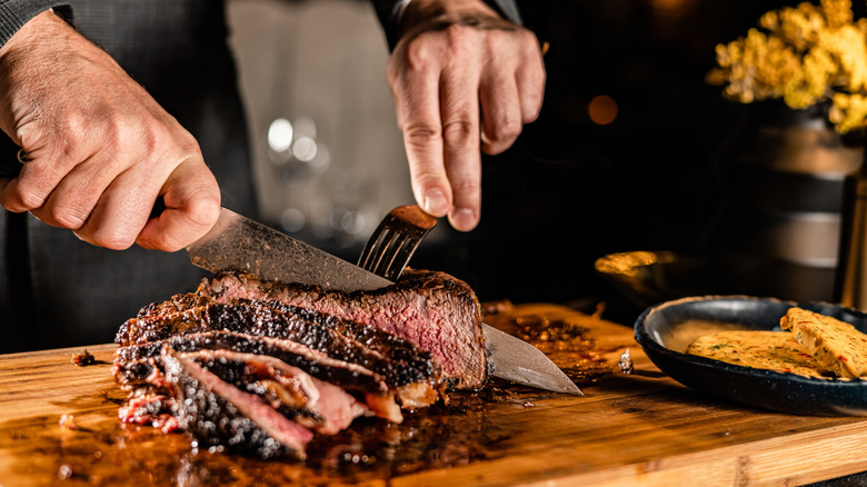 A chef carves up a steak