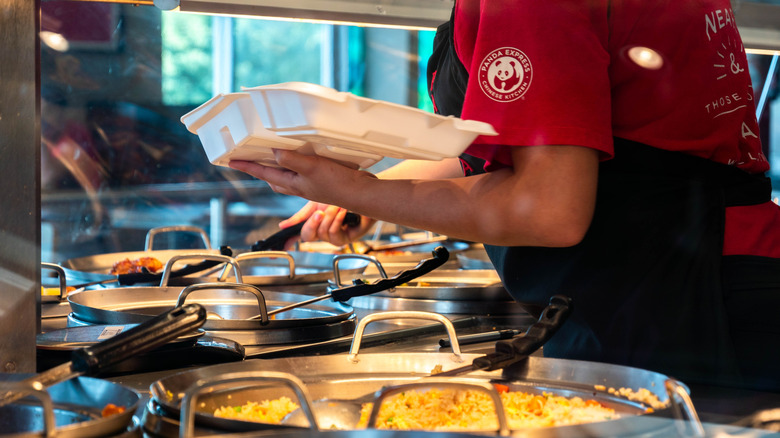 Panda Express worker with to-go box