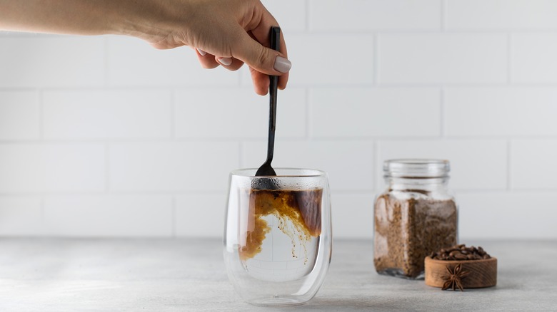 Stirring instant coffee into water