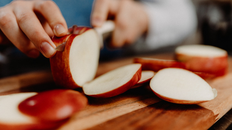 someone chopping apples