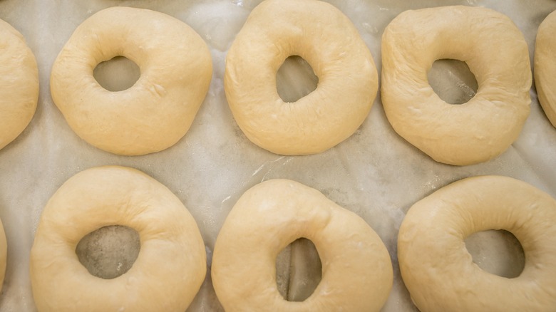 raw bagels on parchment paper