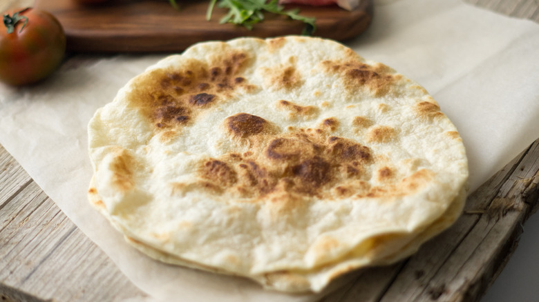 flatbread pizza on parchment paper with fork