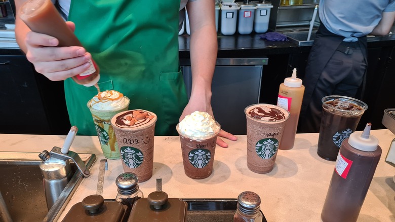 Five Starbucks drink orders on counter 