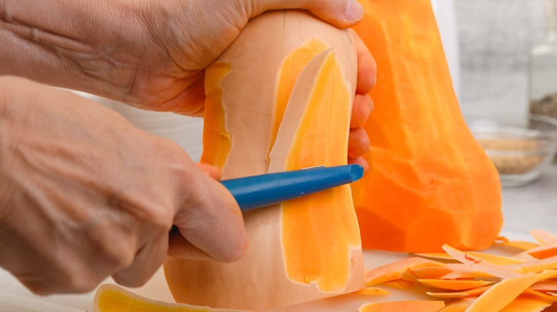 removing squash skin with peeler