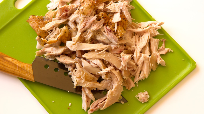 shredded chicken on cutting board