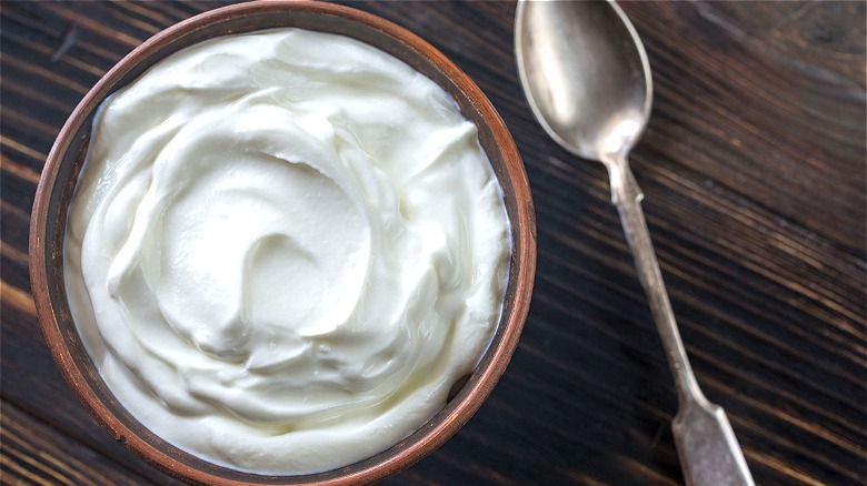 Bowl of Greek yogurt with spoon 