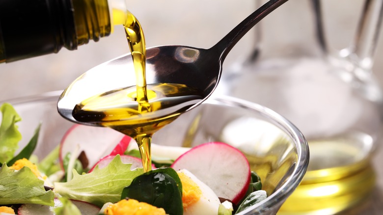 Pouring olive oil onto spoon