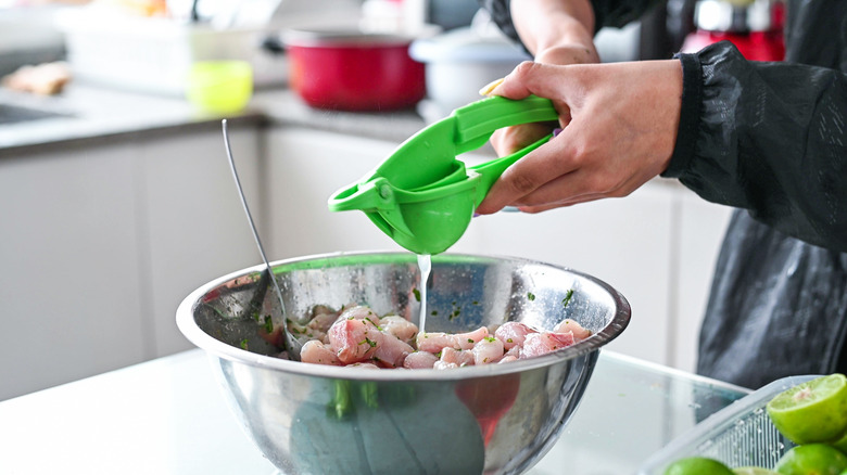 squeezing lime juice in ceviche