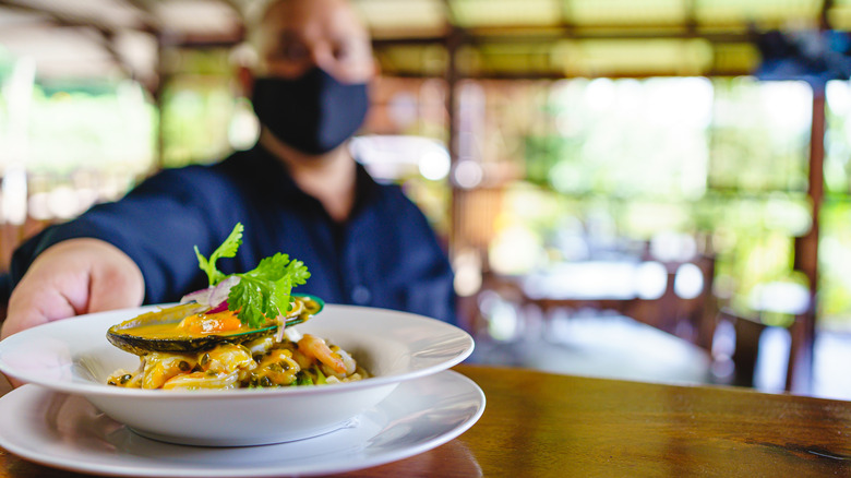 server reaching for ceviche