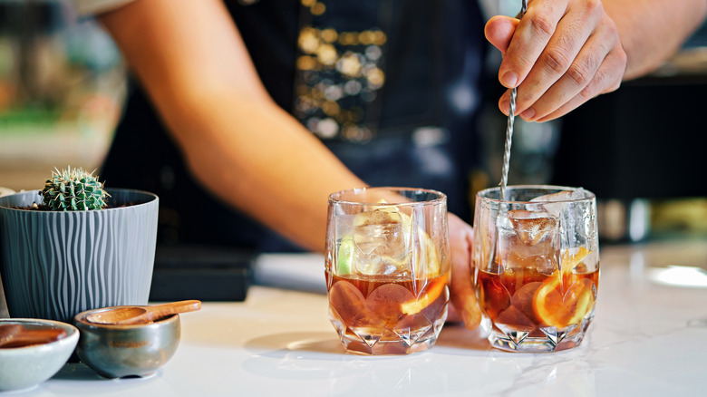 bartender mixing two drinks