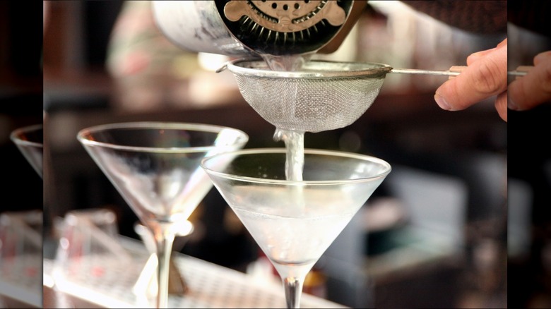 bartender pouring drinks through mesh