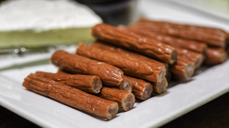 short meat sticks stacked on a plate