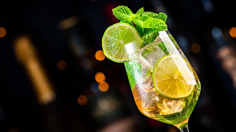 a glass of elderflower spritz with mint and lime