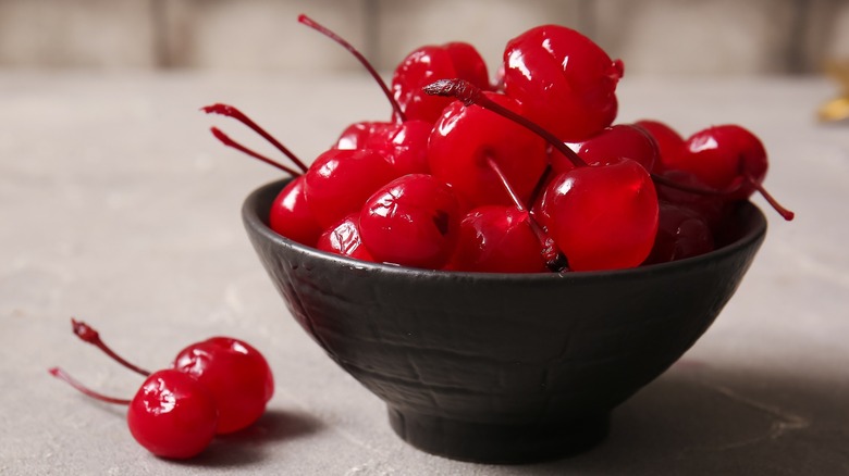 brown bowl of maraschino cherries