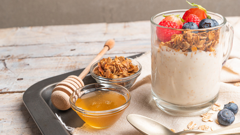 A honey and fruit yogurt parfait on a steel tray