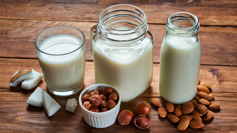 Various plant-based milks in glass containers