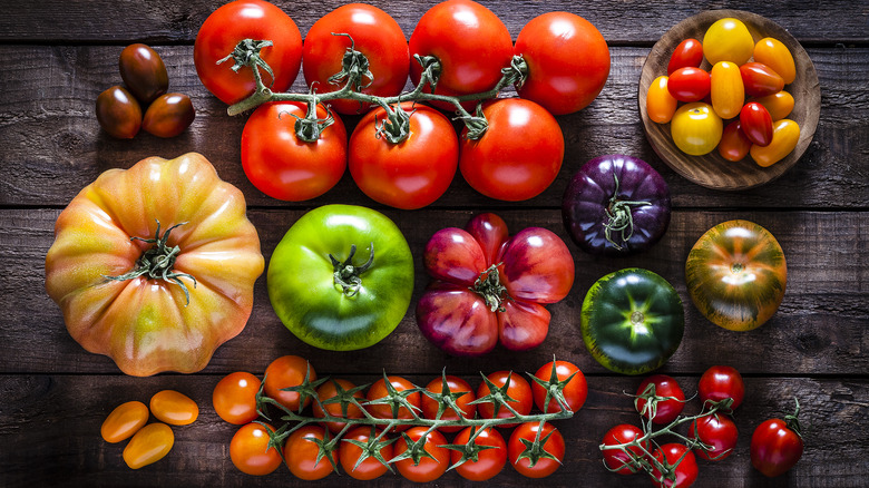 various tomatoes on wooden table