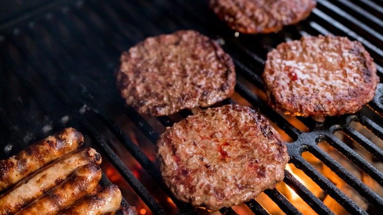 Hamburger patties and hot dogs on a grill