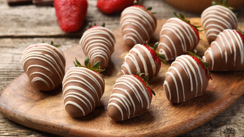 A collection of chocolate covered and drizzled strawberries