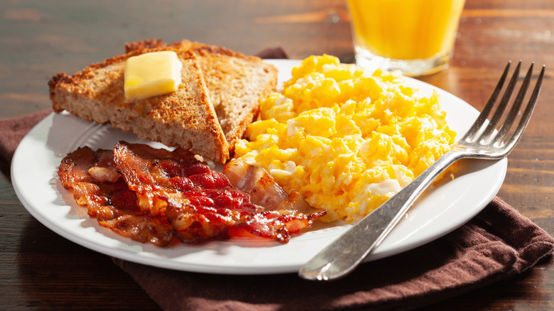 plate with eggs, toast, and bacon