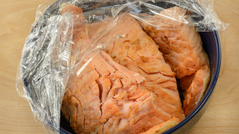 Fish in casserole dish wrapped in plastic