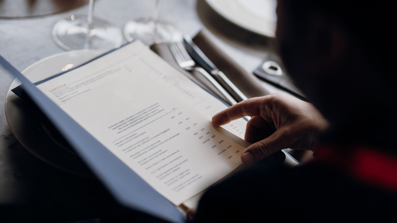 Person pointing to menu item